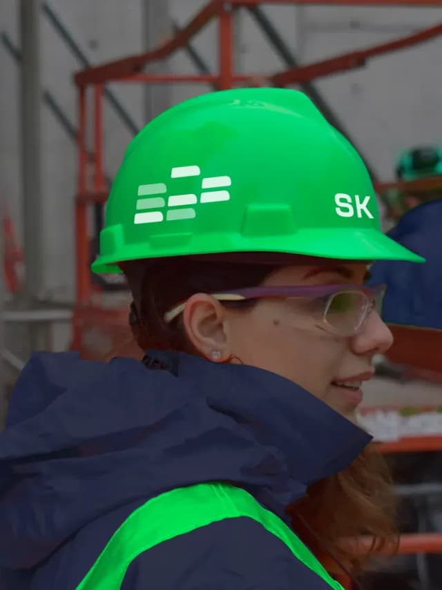 Construction worker wearing a green hard hat