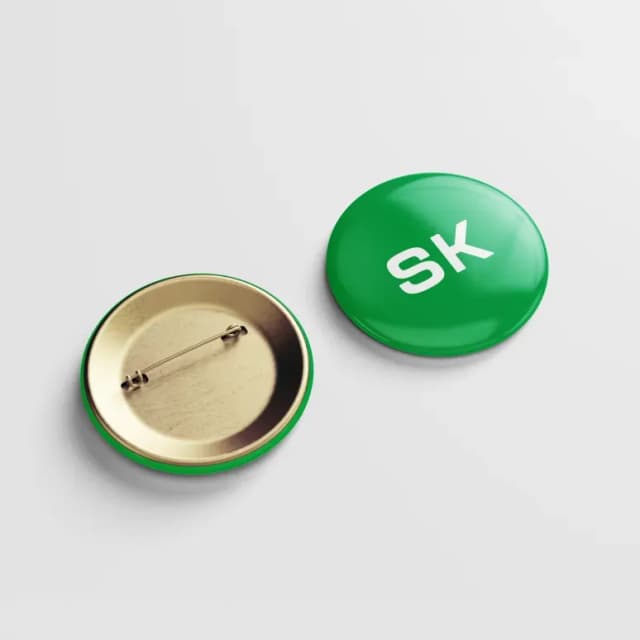 Green button pin with SK logo