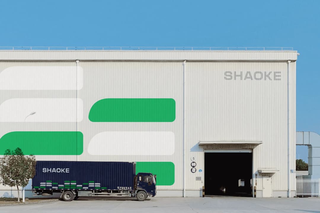 Truck in front of warehouse with branding