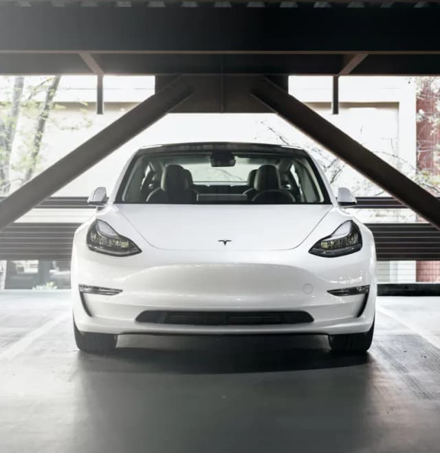 White Tesla Model 3 parked indoors