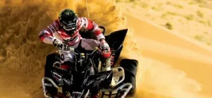 ATV rider in sandy terrain