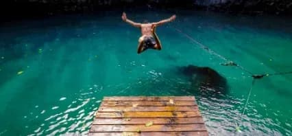 Person diving into turquoise water
