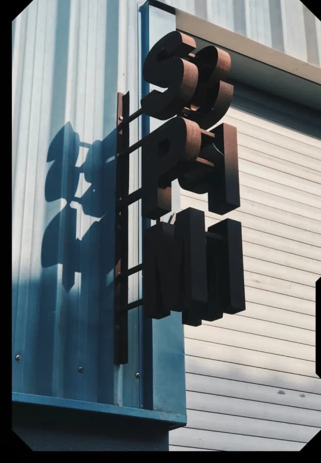 Stylized metal sign on blue wall
