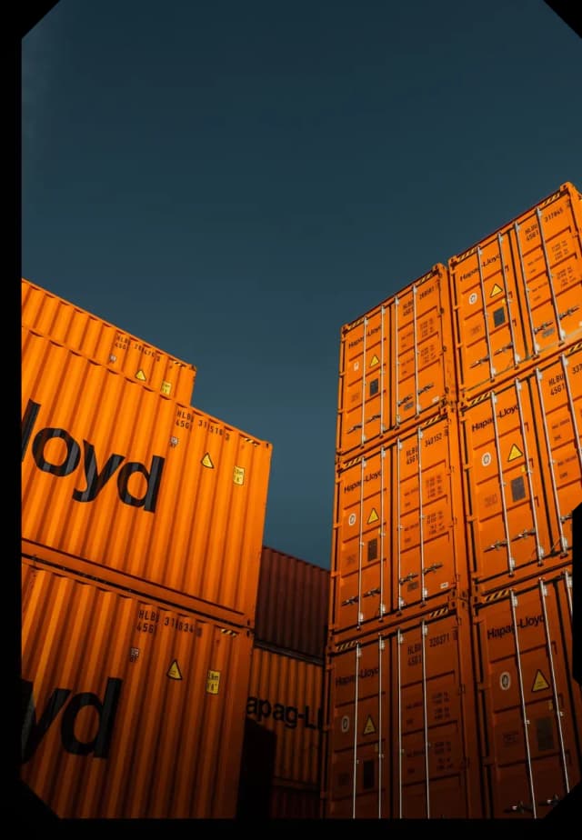 Shipping containers stacked in a storage area