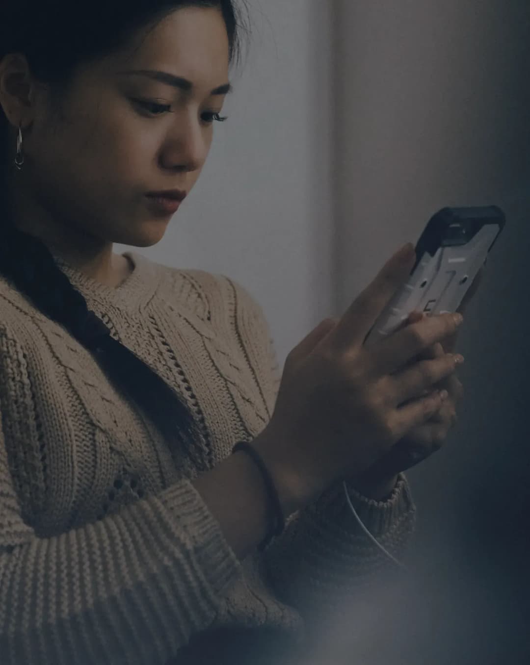 Woman using smartphone while sitting