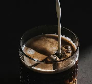 Coffee with milk being poured
