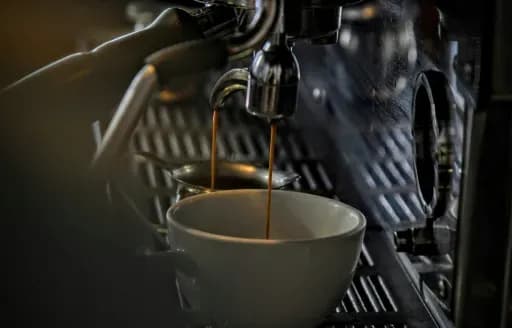 Espresso being brewed into a cup