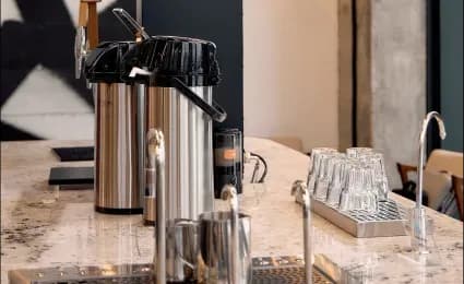 Coffee station with beverage dispensers and glasses
