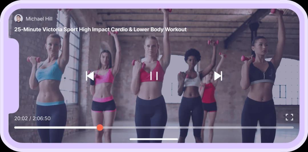 Workout video screen showing five women lifting pink dumbbells in a bright studio.