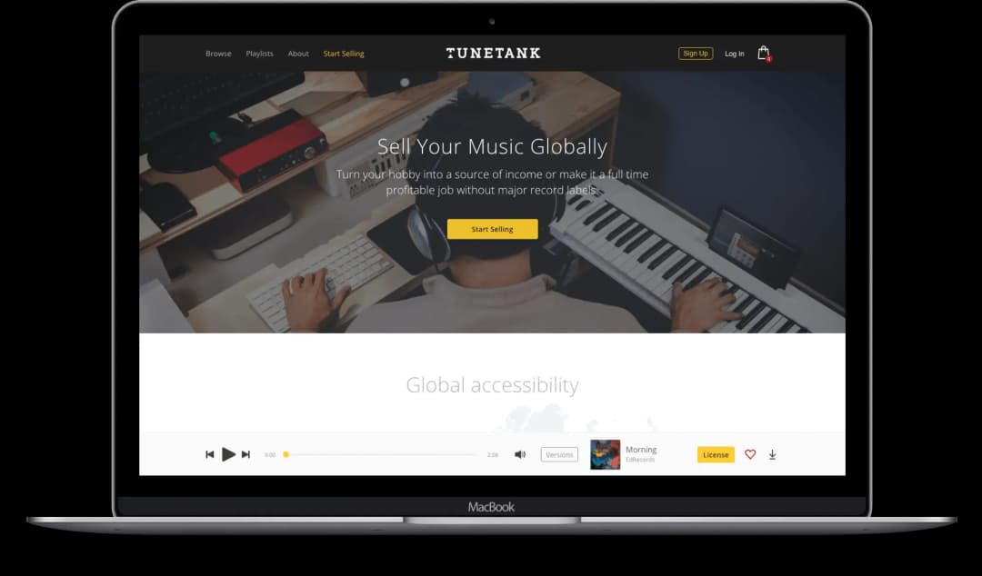 MacBook screen displaying Tunetank website homepage with a musician working on a keyboard and computer, promoting selling music globally.