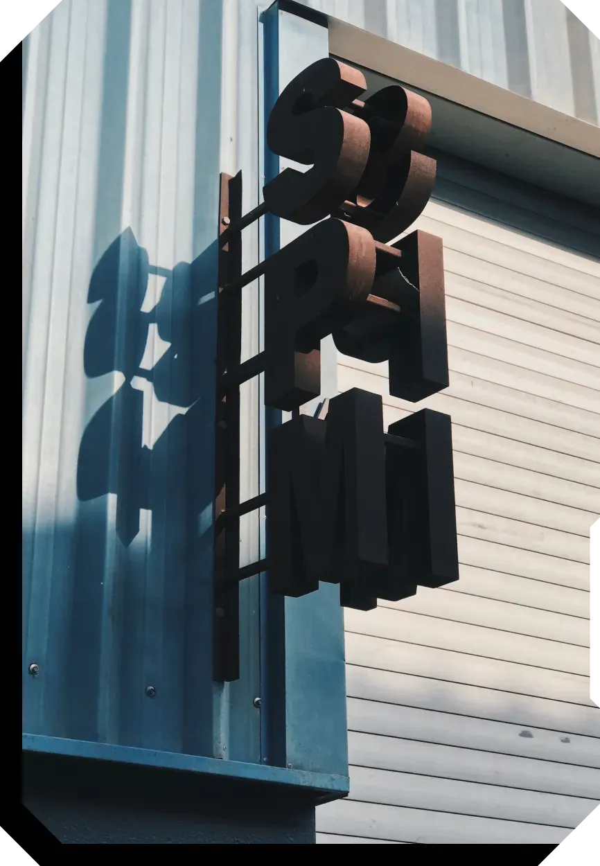 Stylized metal sign on blue wall