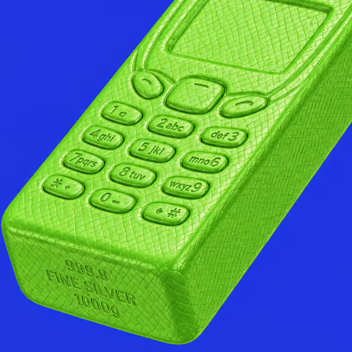 Green sculpture resembling a vintage mobile phone shaped like a silver bar against a blue background.