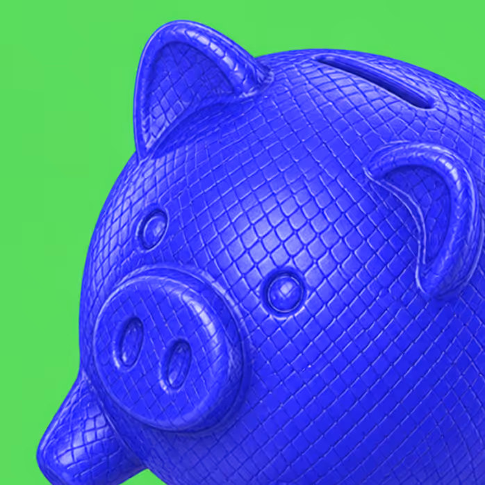 Blue piggy bank with textured diamond pattern on a bright green background.