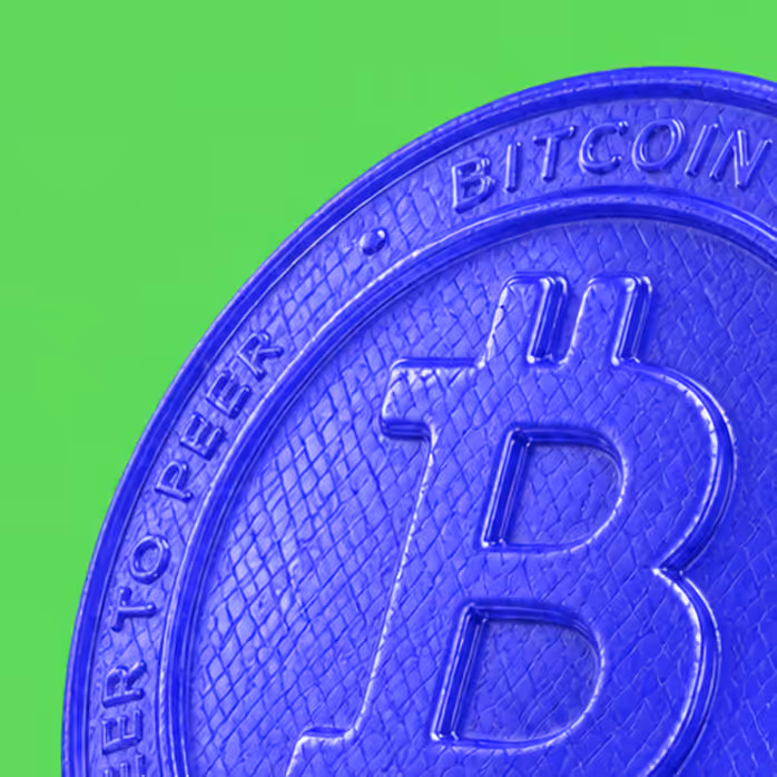 Close-up of a blue Bitcoin coin symbol on a bright green background.