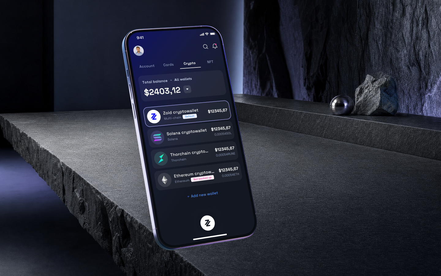 ZoidPay wallets in a phone mockup on a basalt work surface.